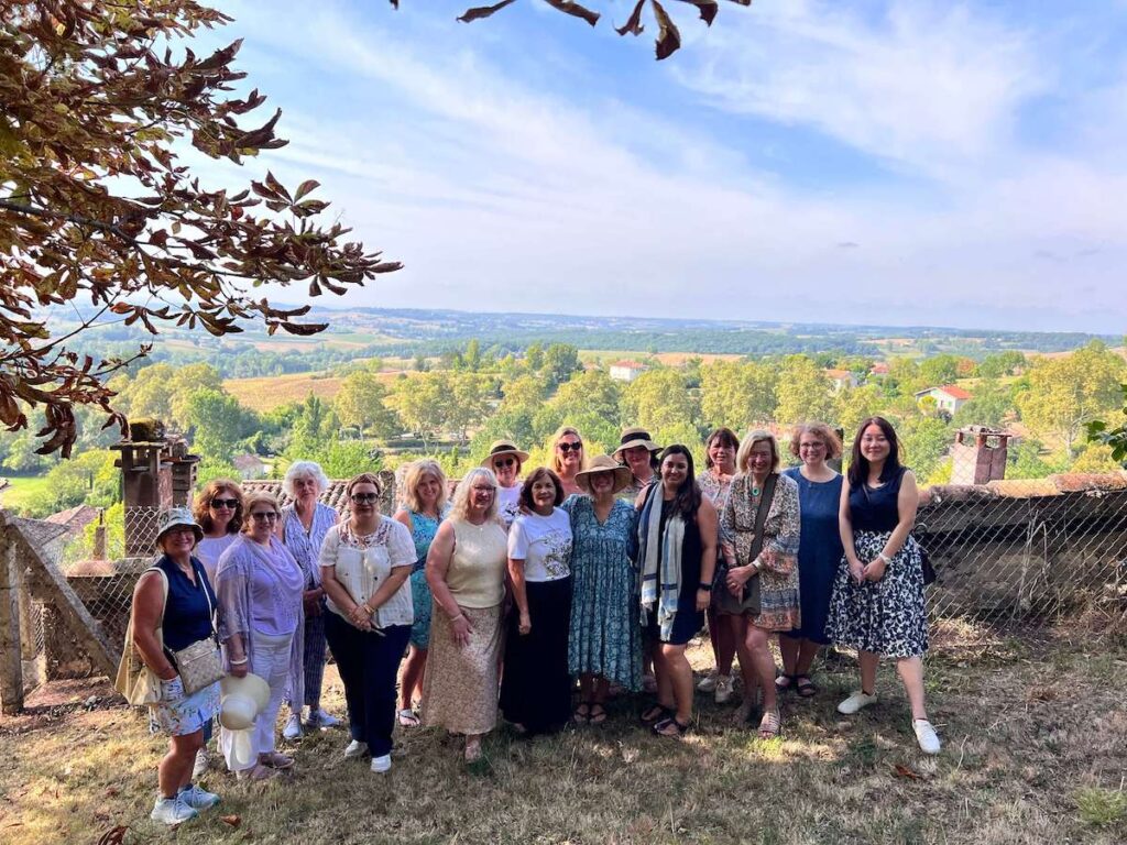 Kelly Rae Roberts with women retreat participants in the French countryside.